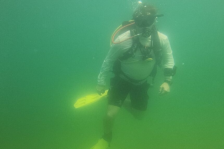 Our tester hovering upright in green freshwater while diving the Oceanic Biolite