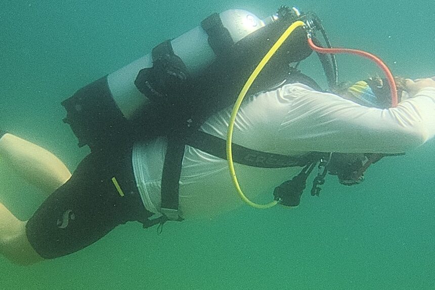 Tester rolling into a head-down position underwater in the Cressi Aquawing backplate and wing