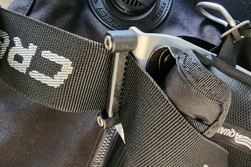 Metal slide buckle threaded through the weave-through webbing harness of the Cressi Aquawing