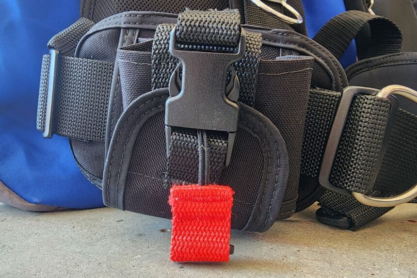 Close-up of the Dive Rite Hydro Lite integrated weight pocket and its red release handle