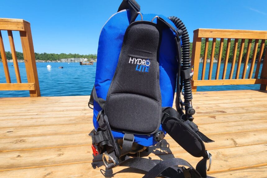 Dive Rite Hydro Lite soft backplate and blue wing standing on a lake dock