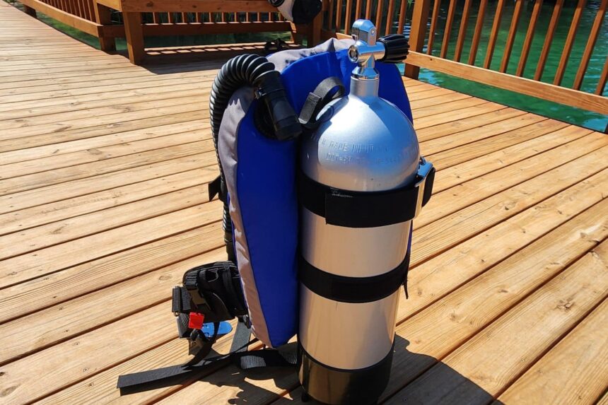 Dive Rite Hydro Lite rigged to a scuba tank on the dock with its harness straps laid out
