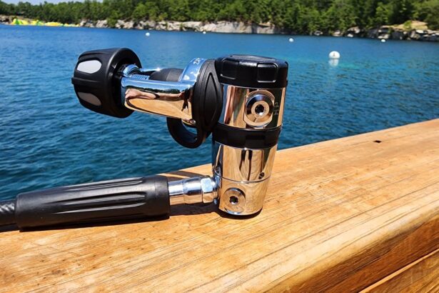 Sherwood SR2 chrome first stage with hose resting on a dock rail above a quarry lake
