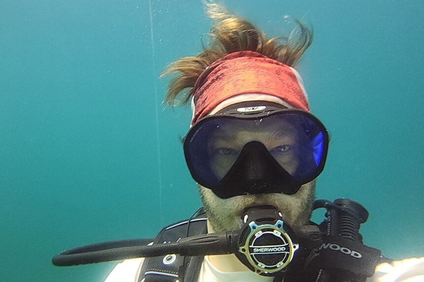 DIVEIN tester facing the camera underwater with the Sherwood SR2 second stage in the mouth