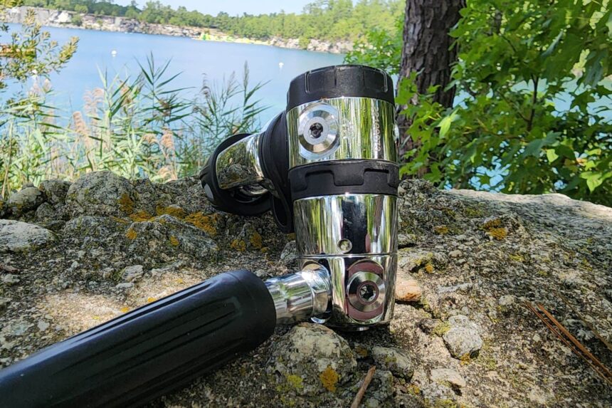 Sherwood SR2 first stage and hose set on a lichen covered rock beside a quarry lake