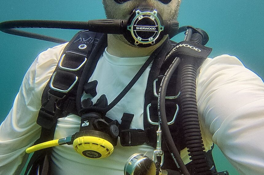 Our tester underwater in a Sherwood Avid BCD breathing from the SR2 with a yellow octopus clipped on