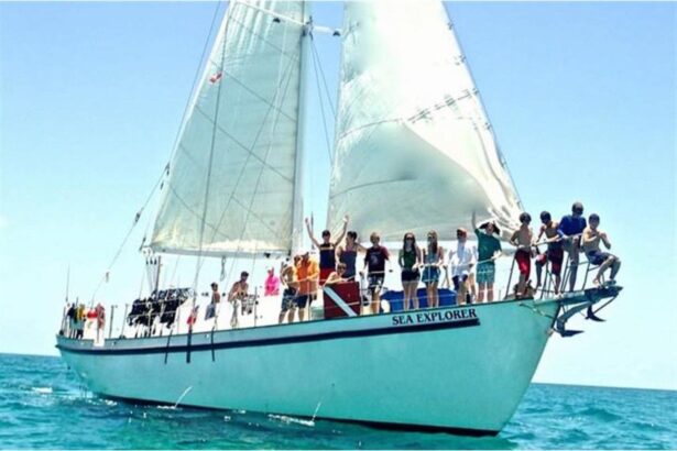 Blackbeard's Sea Explorer under full sail with guests lined along the rail waving