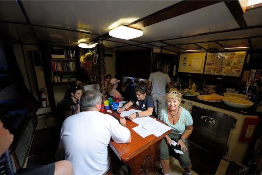 Guests gathered around the dining table aboard Blackbeard's Sea Explorer
