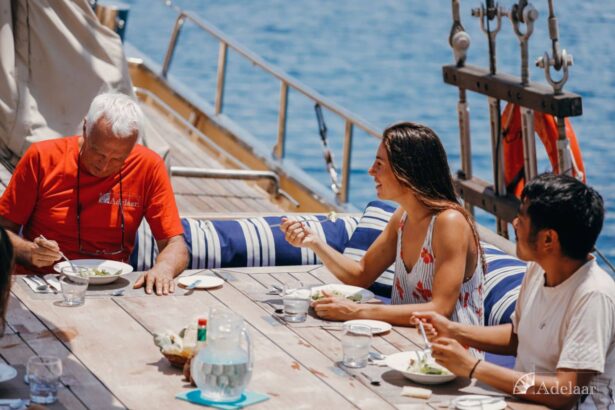 guests laughing over lunch at a shaded table on the Adelaar's deck