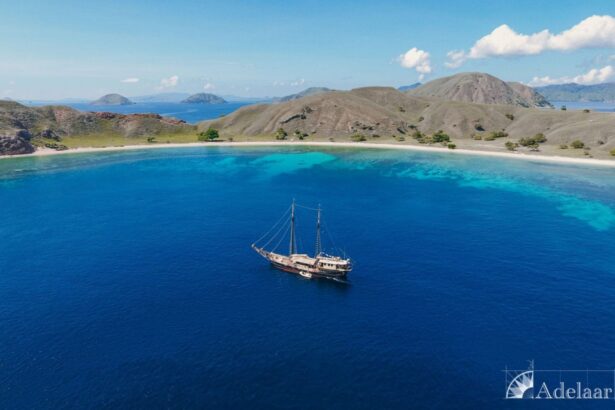 Adelaar sailing yacht anchored in a turquoise bay surrounded by hills
