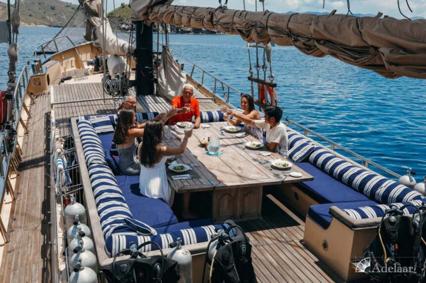 guests raising glasses together at a dining table on the Adelaar's deck