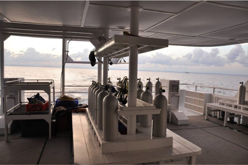 rows of scuba tanks and regulators set up on the Infiniti's dive deck