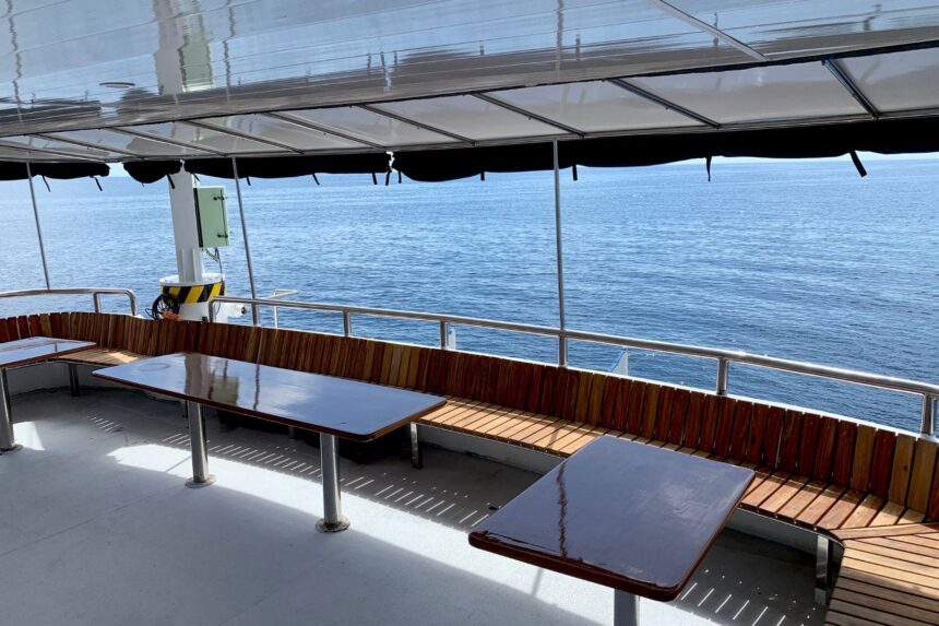 covered outdoor dining deck aboard the Infiniti overlooking the sea