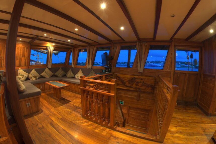 Cozy indoor lounge salon aboard the Damai I liveaboard at dusk