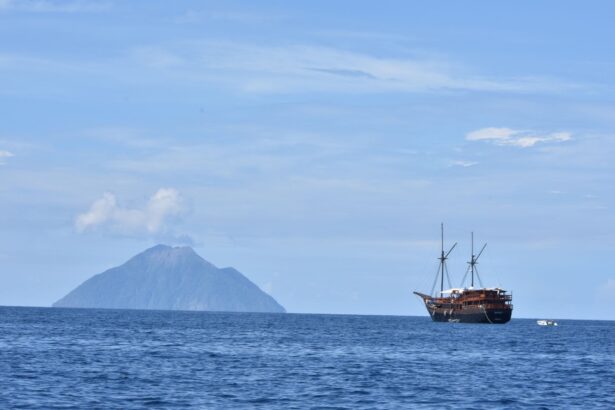 The Damai II anchored near a distant volcanic island
