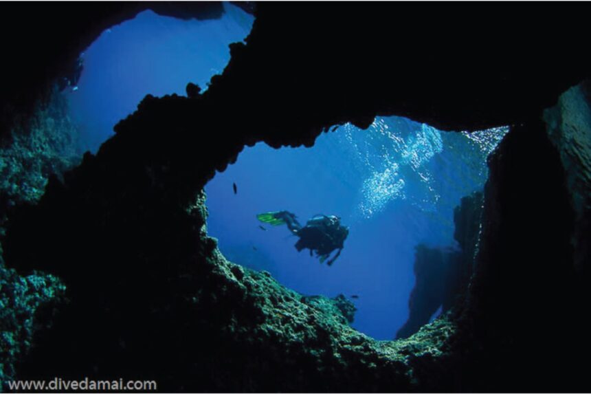 Scuba tanks and towels staged on the shaded dive deck of the Damai II