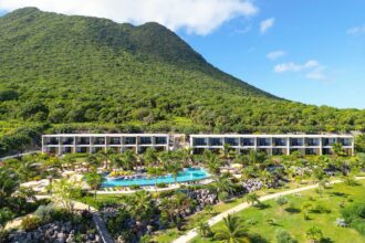 Aerial view of Golden Rock Resort's pool and guest wings beneath the Quill volcano
