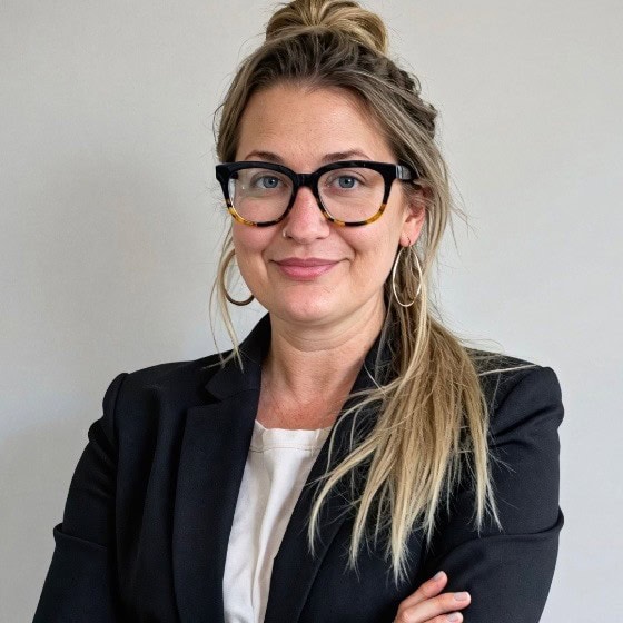 Headshot of Summer Worsley, DIVEIN author, wearing glasses and a black blazer