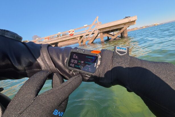 Tester pressing the Suunto Nautic's buttons with thick neoprene gloves at the surface