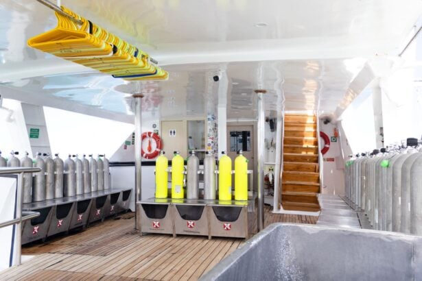 Dive deck of the Humboldt Explorer with rows of tanks, gear lockers and a wooden staircase