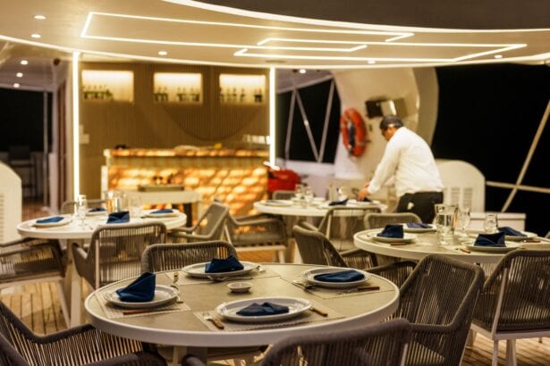 Guests dining at candlelit tables on the Humboldt Explorer's upper deck at night