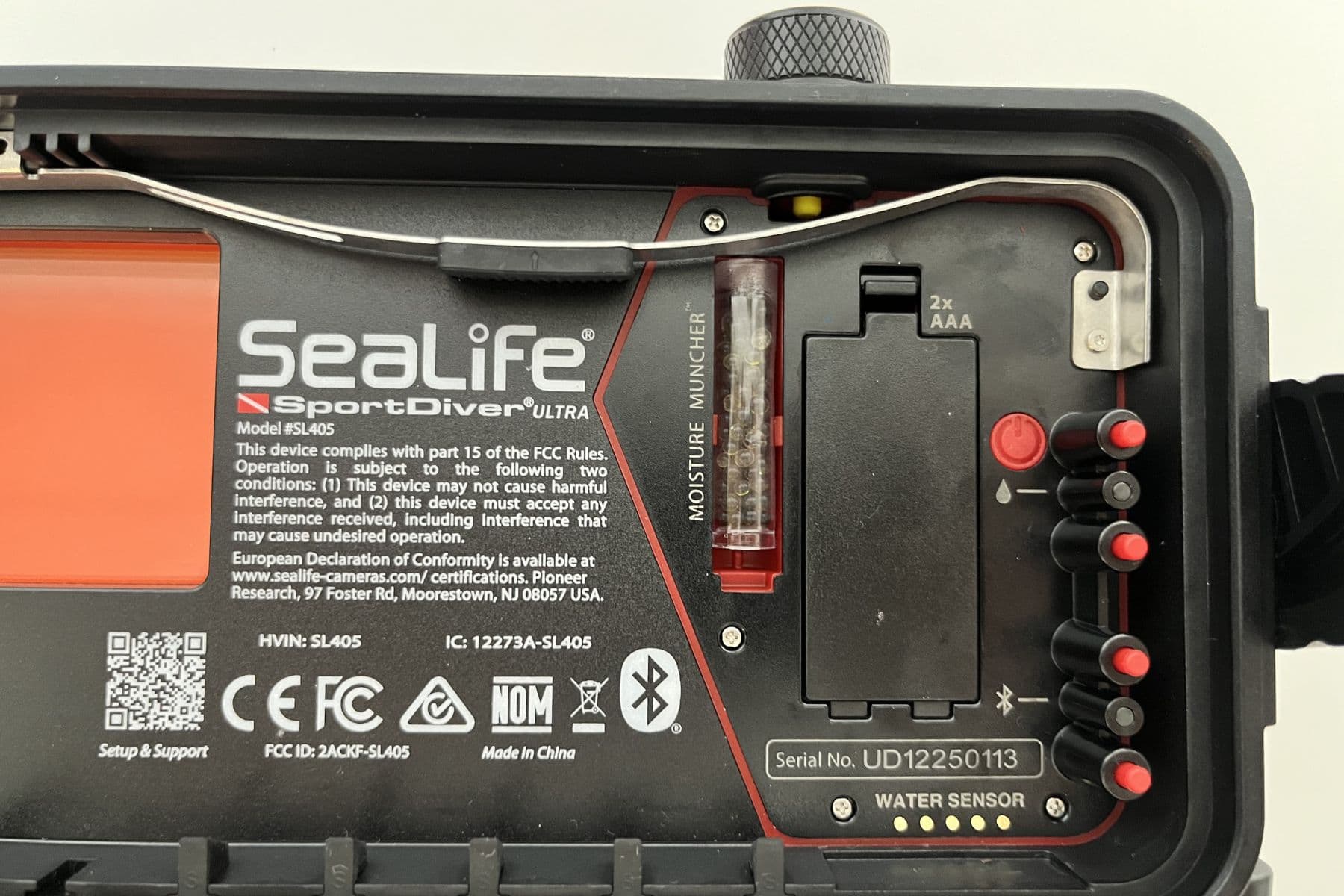 Inside of the SeaLife SportDiver Ultra showing the Moisture Muncher strip, AAA battery bay and water sensor