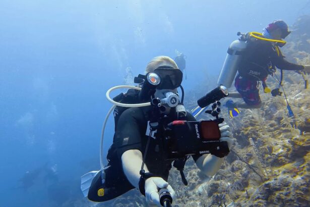 Our tester swimming with the SeaLife SportDiver Ultra on a tray with a video light fitted