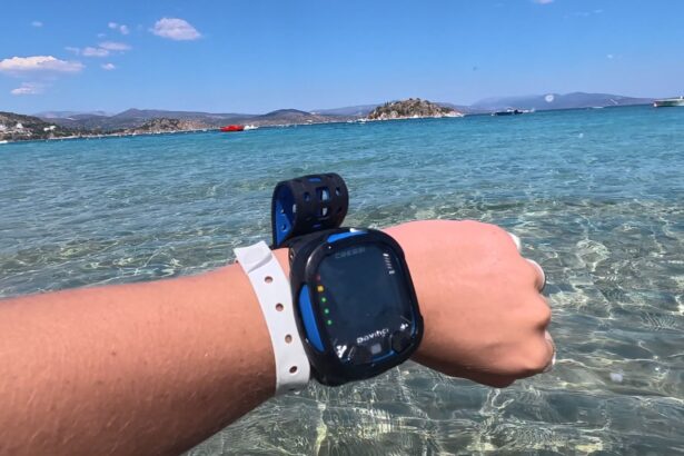 close view of a Cressi Da Vinci dive computer on the wrist with the sea in the background