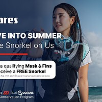 A snorkeller on a beach wearing a Mares mask and snorkel, beside the Dive Into Summer free snorkel promotion details